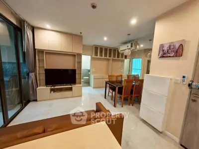 Modern living room with open layout, stylish furniture, and dining area in a contemporary apartment.