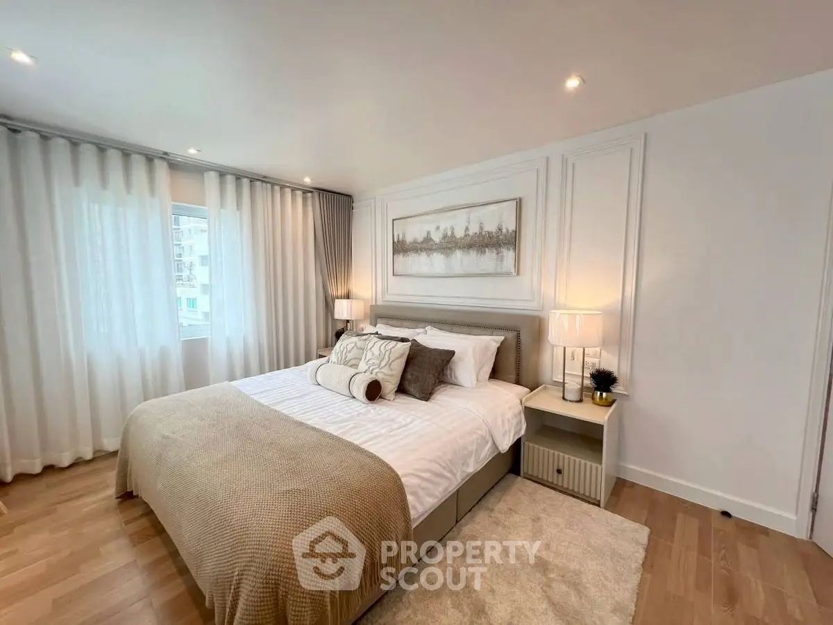 Elegant bedroom with cozy decor and natural light, featuring a comfortable bed and stylish furnishings.