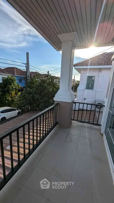 Spacious balcony with modern railing and scenic view, perfect for relaxation.