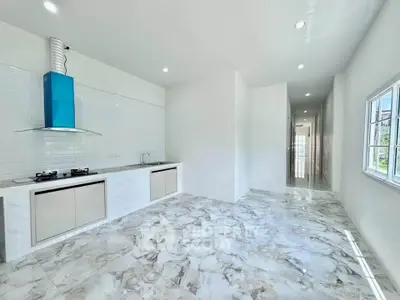 Spacious modern kitchen with marble flooring and sleek design