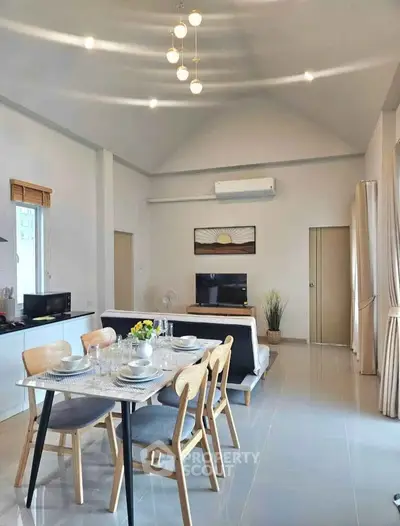 Modern open-plan living and dining area with stylish decor and ample natural light.