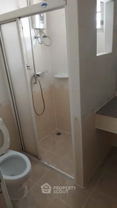 Compact bathroom with shower and toilet in modern apartment