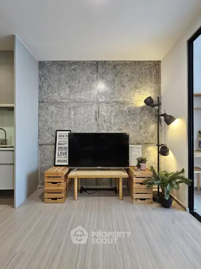 Modern living room with concrete accent wall and stylish decor