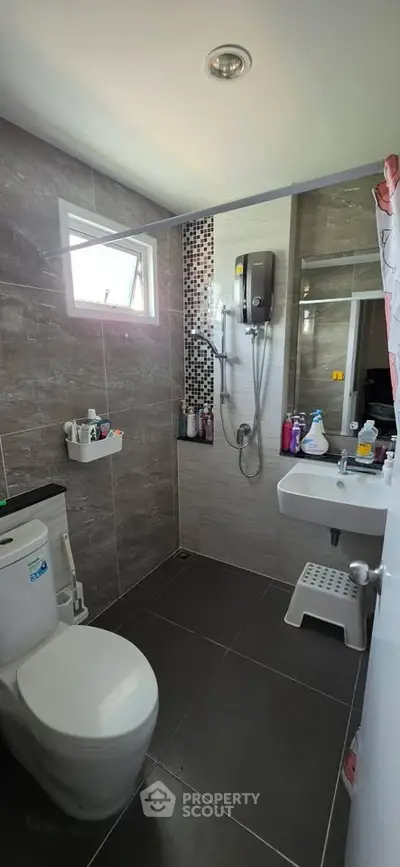Modern bathroom with sleek tiles and contemporary fixtures in a stylish home.