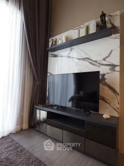 Luxurious living room with marble accent wall and modern TV setup