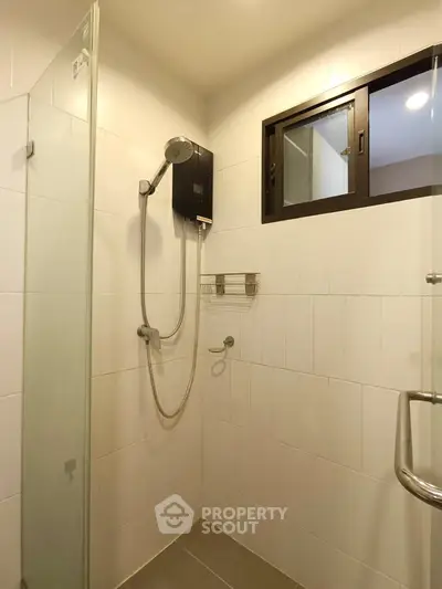 Modern bathroom with glass shower enclosure and sleek fixtures