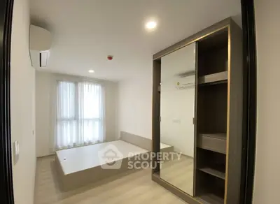 Modern bedroom with sleek design and mirrored wardrobe