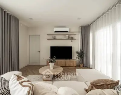 Elegant living room with modern decor, neutral tones, and cozy seating, perfect for relaxation and entertainment.