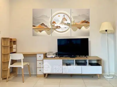 Modern living room with stylish furniture and wall art, featuring a TV and a desk area.