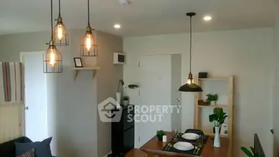 Modern living room with stylish lighting and dining area, perfect for cozy gatherings.