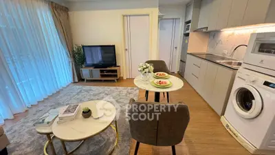 Modern living room with open kitchen, featuring stylish furniture and appliances, perfect for urban living.