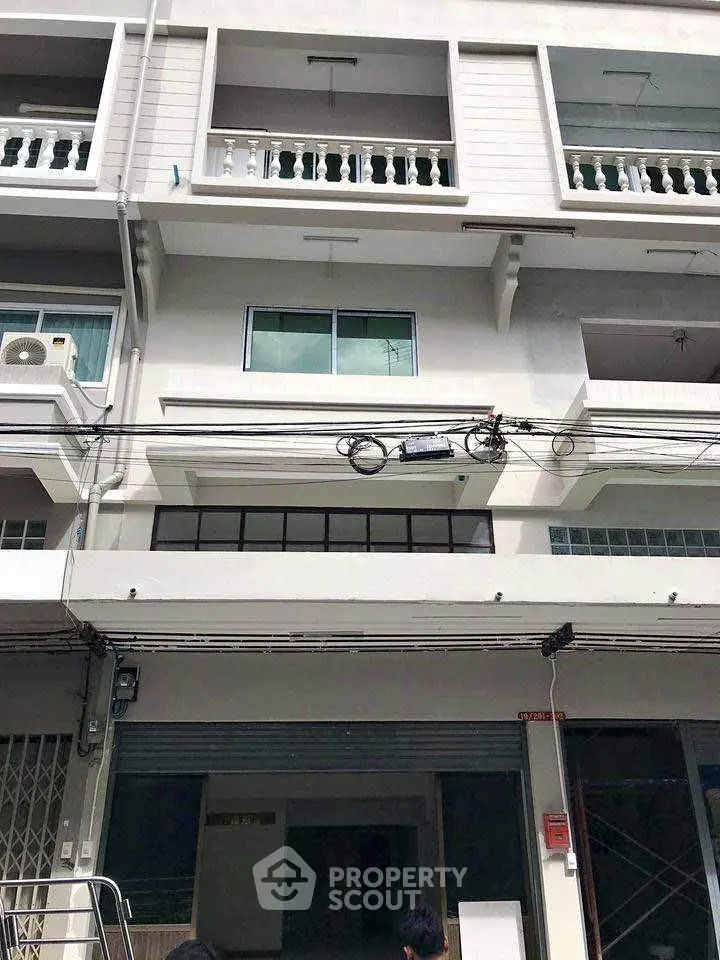 Modern multi-story building with balconies and large windows, ideal for urban living or commercial use.
