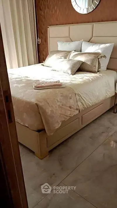 Cozy bedroom with elegant decor and plush bedding in a modern apartment.