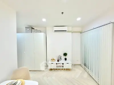 Modern minimalist living room with white furniture and air conditioning