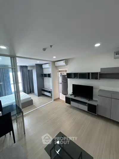 Modern living room with sleek furniture and open layout in a stylish apartment.