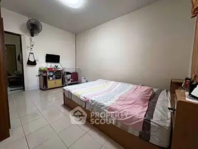 Cozy bedroom with modern amenities and tiled flooring, perfect for comfortable living.
