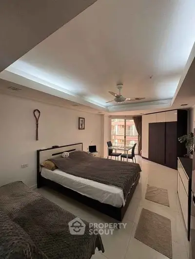 Spacious bedroom with modern furnishings and natural light