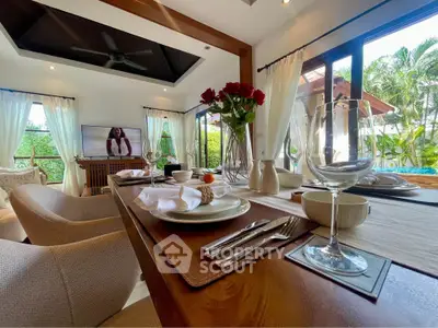 Luxurious open-plan living room with elegant dining setup and garden view, perfect for entertaining.
