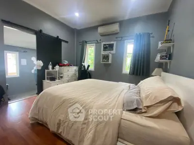 Cozy bedroom with modern decor and natural light, featuring a comfortable bed and stylish furnishings.