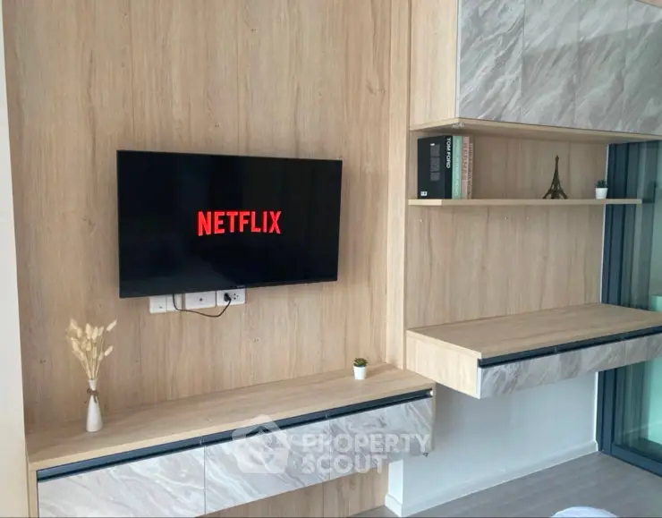 Modern living room with wall-mounted TV and stylish wooden cabinetry