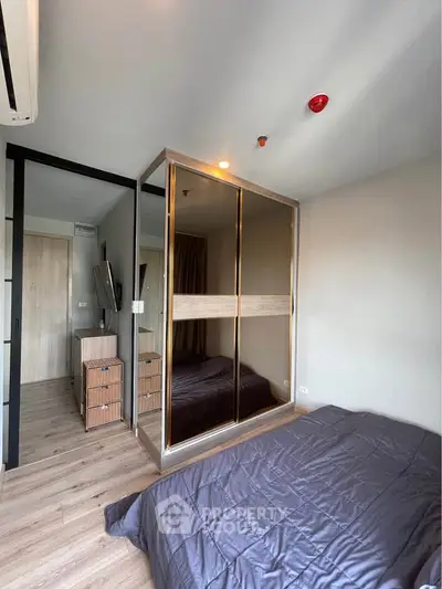 Modern bedroom with mirrored wardrobe and stylish decor
