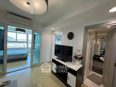 Modern apartment interior with open living area and bedroom view