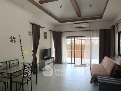 Spacious living room with modern decor and large windows for natural light.