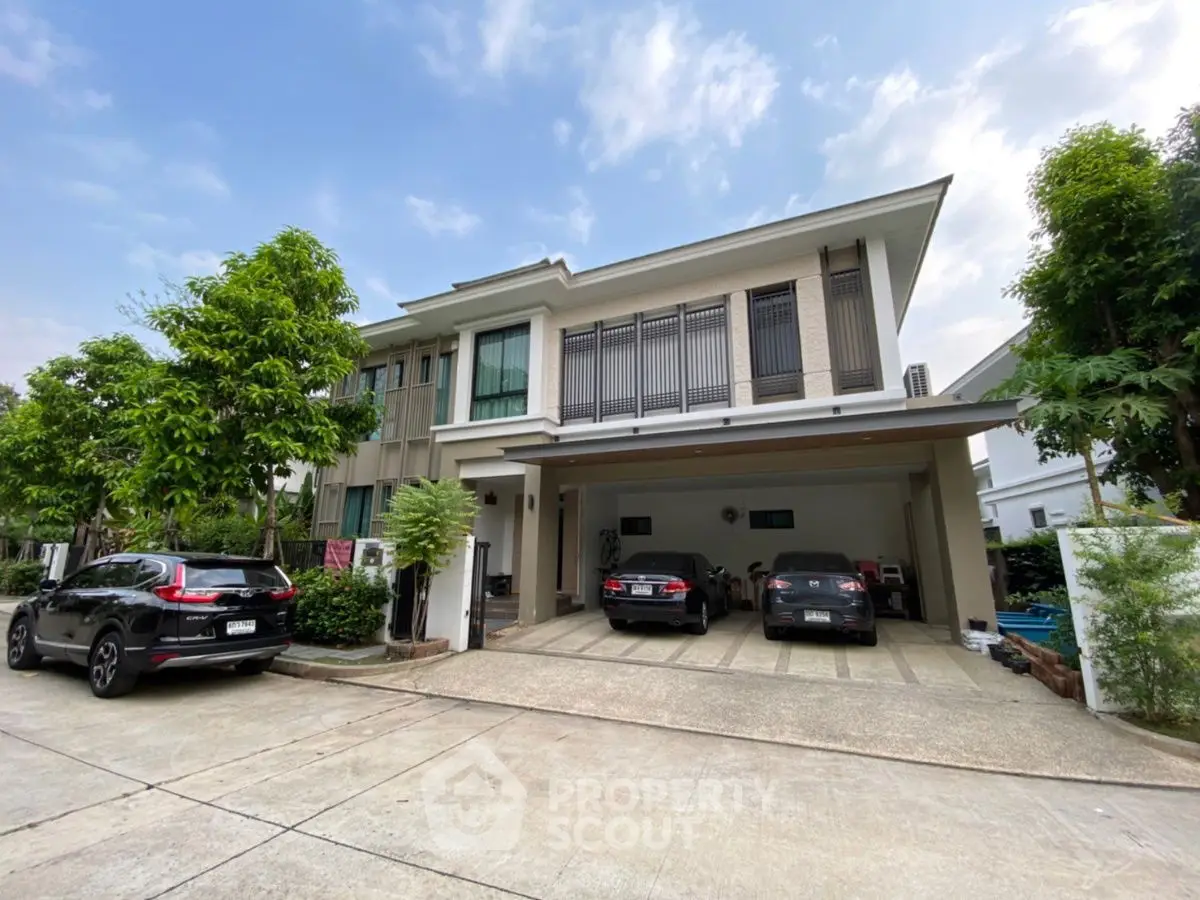 Modern two-story house with spacious driveway and lush greenery