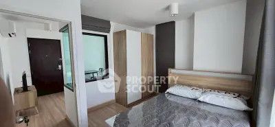 Modern bedroom with stylish decor and natural light, featuring a cozy bed and sleek wardrobe.