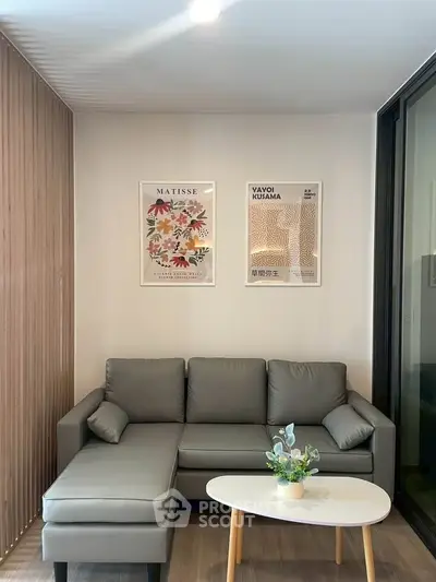 Modern living room with stylish gray sofa and art decor, perfect for relaxation and contemporary living.