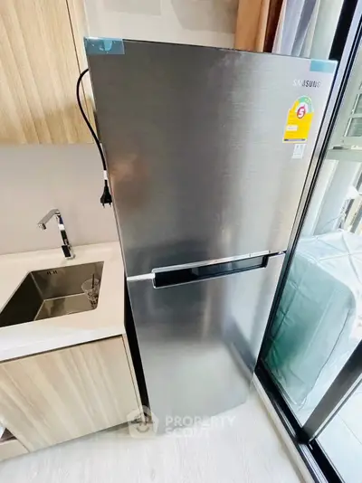 Modern kitchen with sleek stainless steel fridge and stylish sink