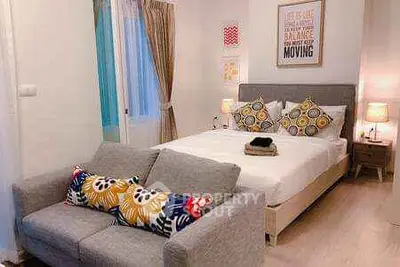 Cozy bedroom with stylish decor and comfortable seating area