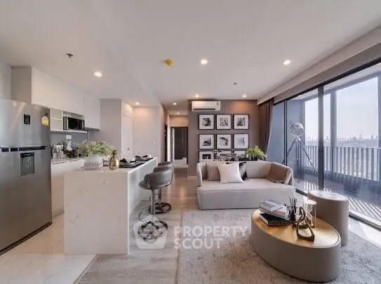 Modern open-plan living room with kitchen, stylish decor, and balcony view.
