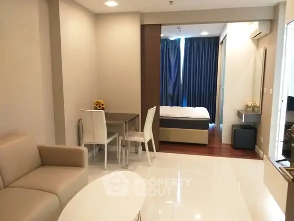 Modern studio apartment with cozy living area and bedroom