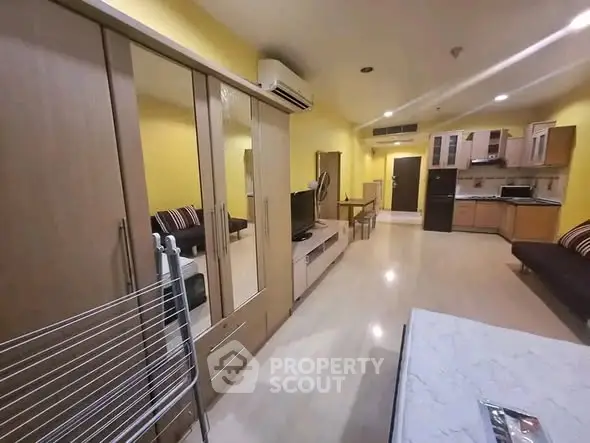 Spacious open-plan living room with modern kitchen and stylish decor