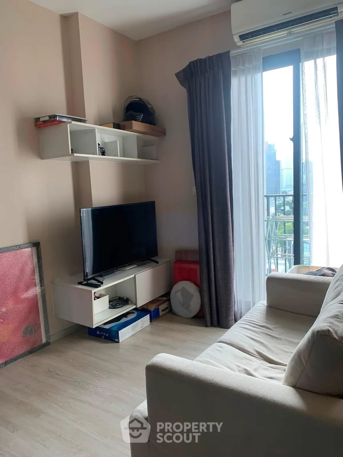 Cozy living room with modern decor and city view from balcony