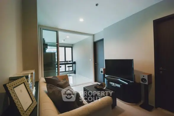 Modern living room with cozy sofa and entertainment setup in stylish apartment.