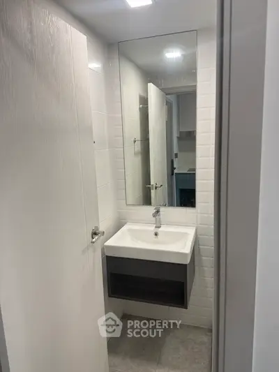 Modern bathroom with sleek sink and mirror in contemporary apartment