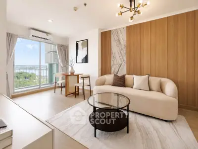 Stylish modern living room with elegant decor and large window offering scenic views.