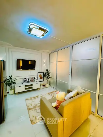 Modern living room with cozy sofa, stylish decor, and ambient lighting