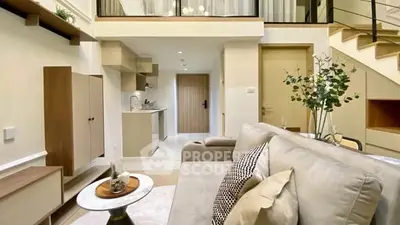 Modern duplex living room with stylish decor and open kitchen layout