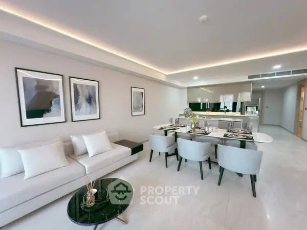 Modern open-plan living and dining area with sleek design and elegant furnishings.