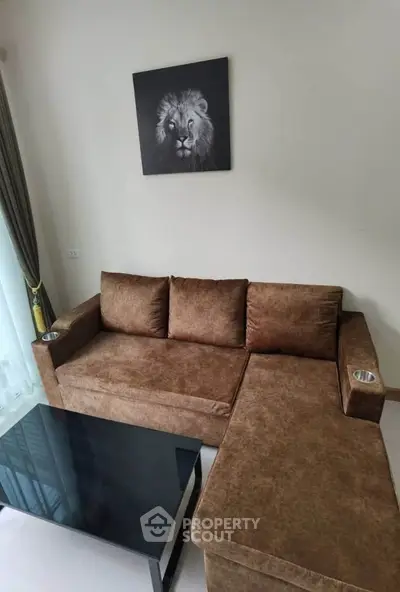 Modern living room with brown sectional sofa and lion artwork, perfect for cozy relaxation.