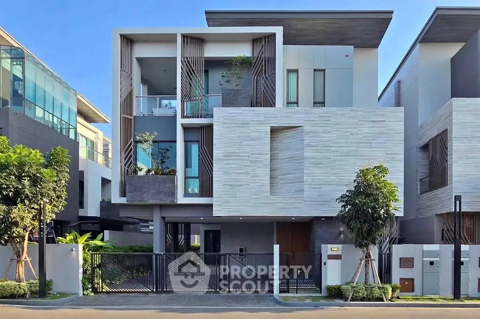 Modern architectural masterpiece with sleek design and lush greenery in a prime residential area.