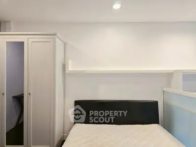 Modern minimalist bedroom with sleek design and ample storage space.