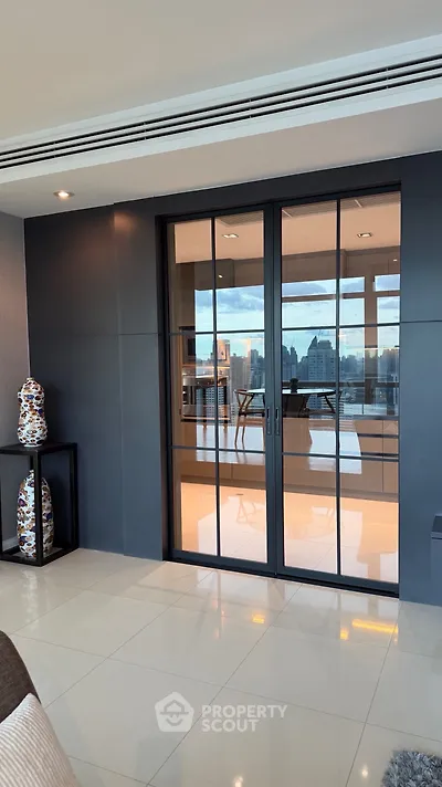 Luxurious modern living room with city view and elegant glass doors