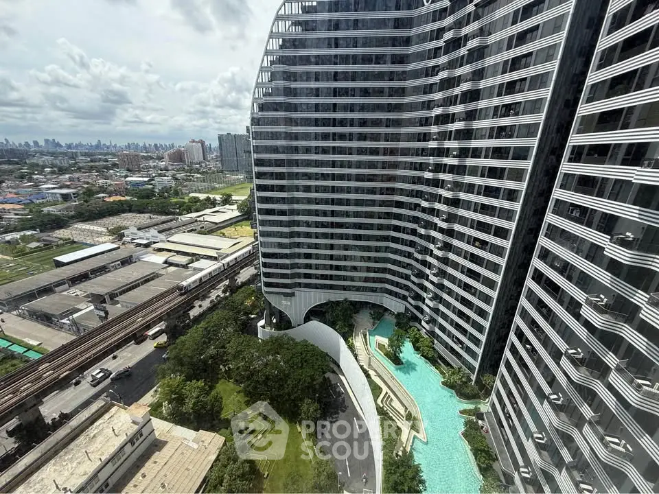 Stunning high-rise building with modern architecture and pool view in urban setting.