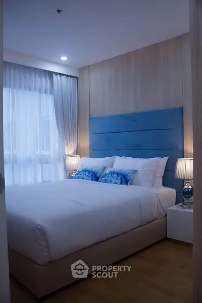 Cozy modern bedroom with elegant blue accents and soft lighting