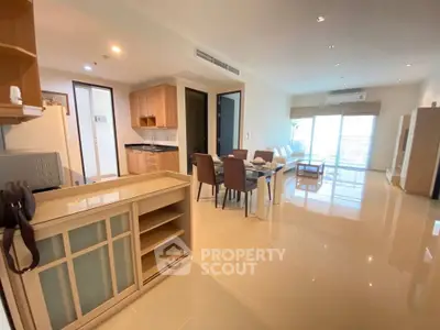 Spacious open-plan living room with modern furniture and natural light