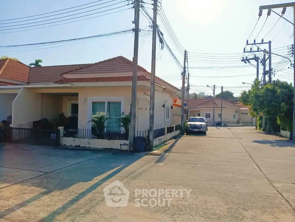 Charming suburban house with driveway and car, perfect for family living.